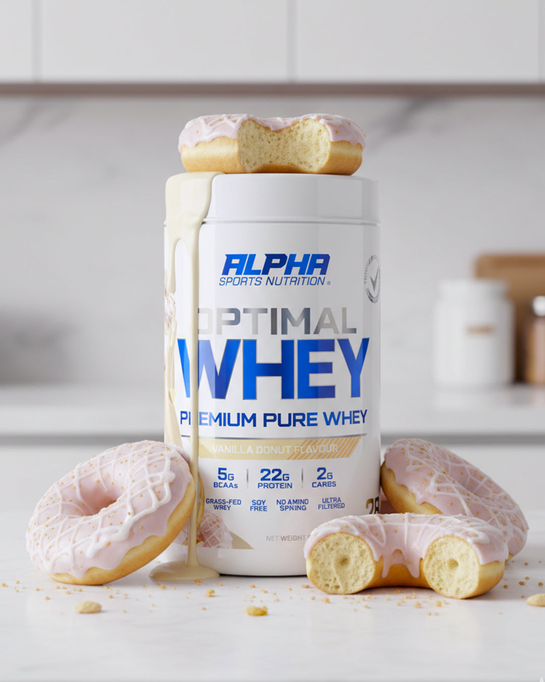 Alpha Sports Nutrition Optimal Whey protein container with donuts on a kitchen counter.