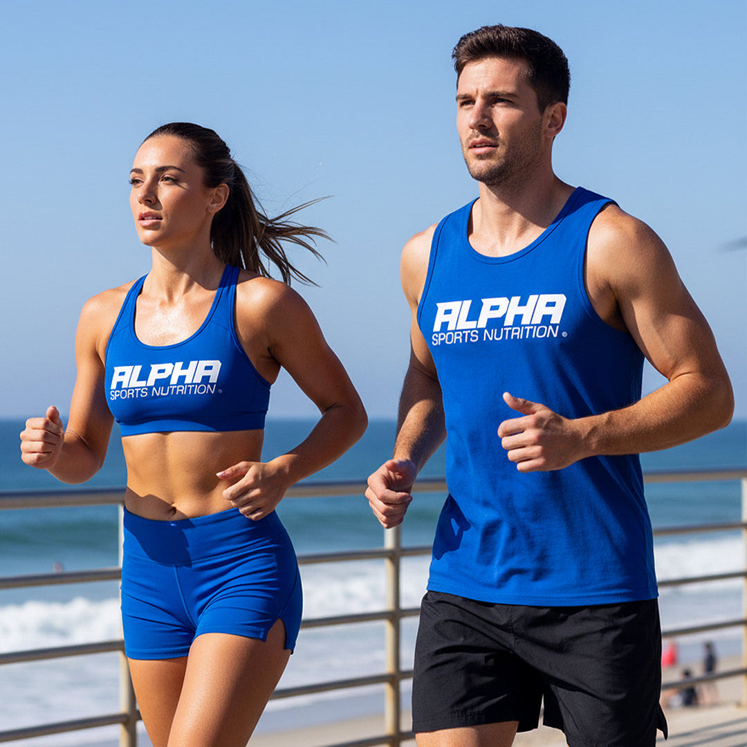 Two people wearing Alpha Sports Nutrition athletic wear running on a beach.